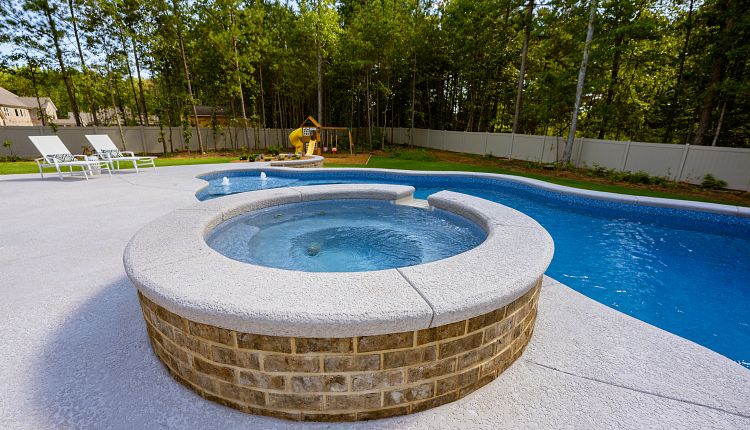 Benefits of Adding a Spillover Spa to Your Custom Pool